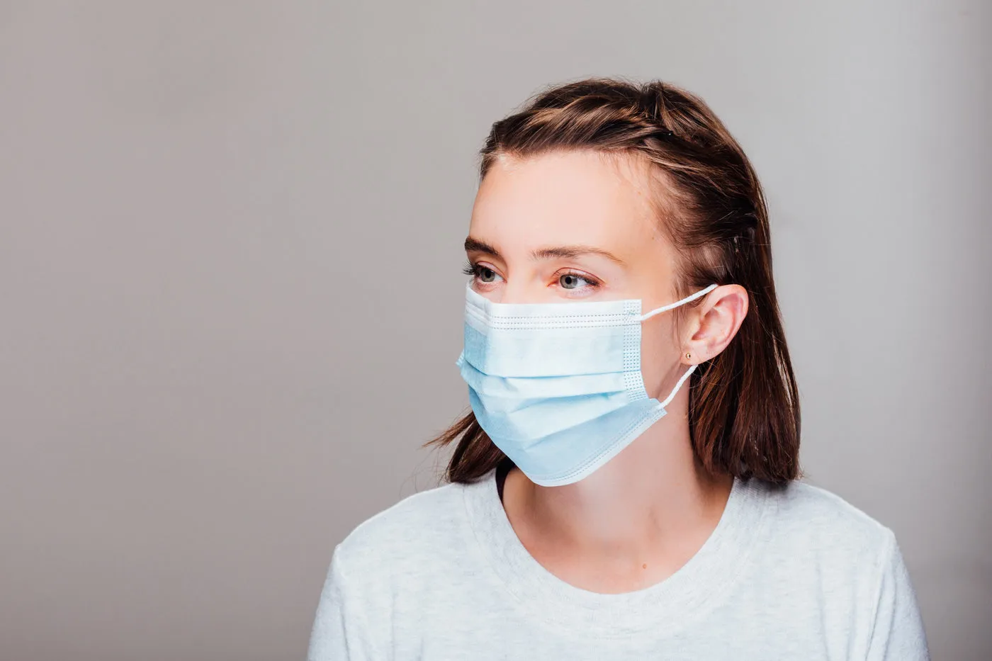 Portrait Of A Woman Wearing Disposable Face Mask