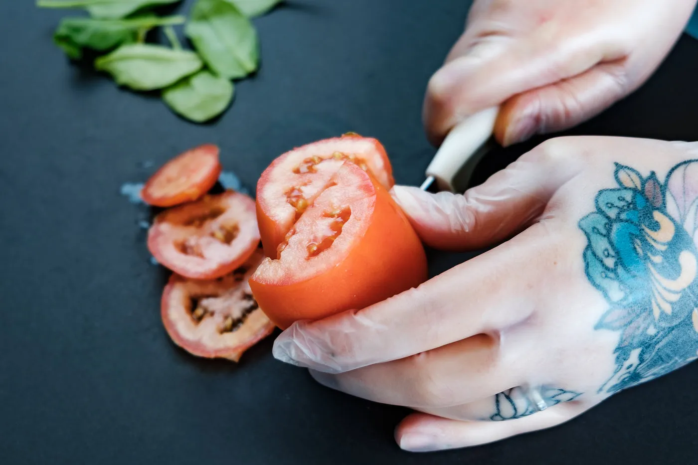 Tattooed Hands Preparing Food With Gloves