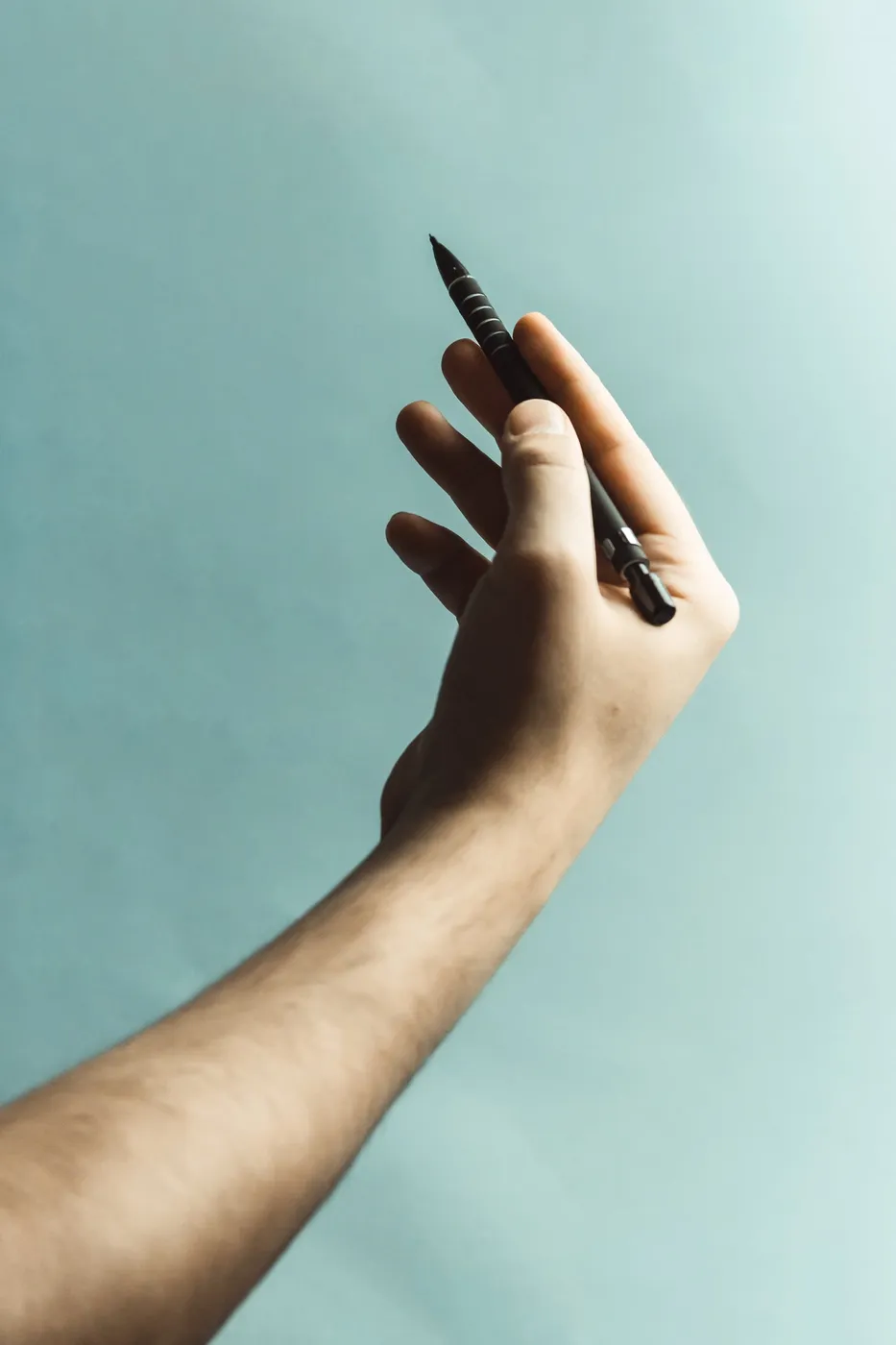 Hand Holding A Pen Photo